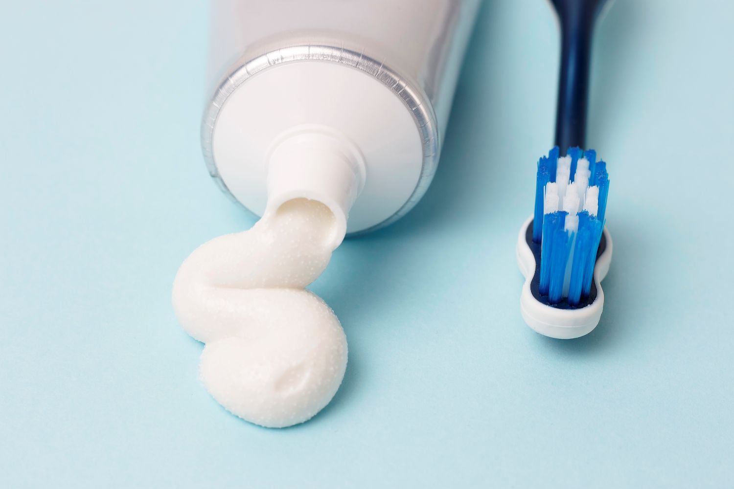 Toothpaste next to toothbrush